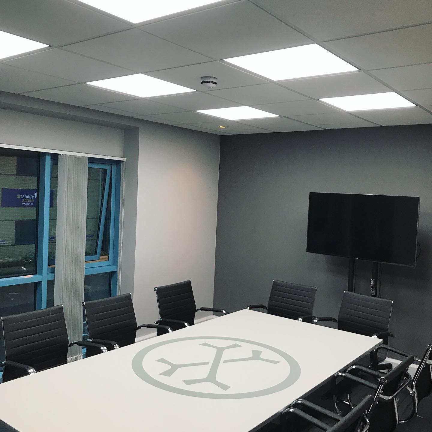 Completed commercial lighting in an OsteoStrong meeting room