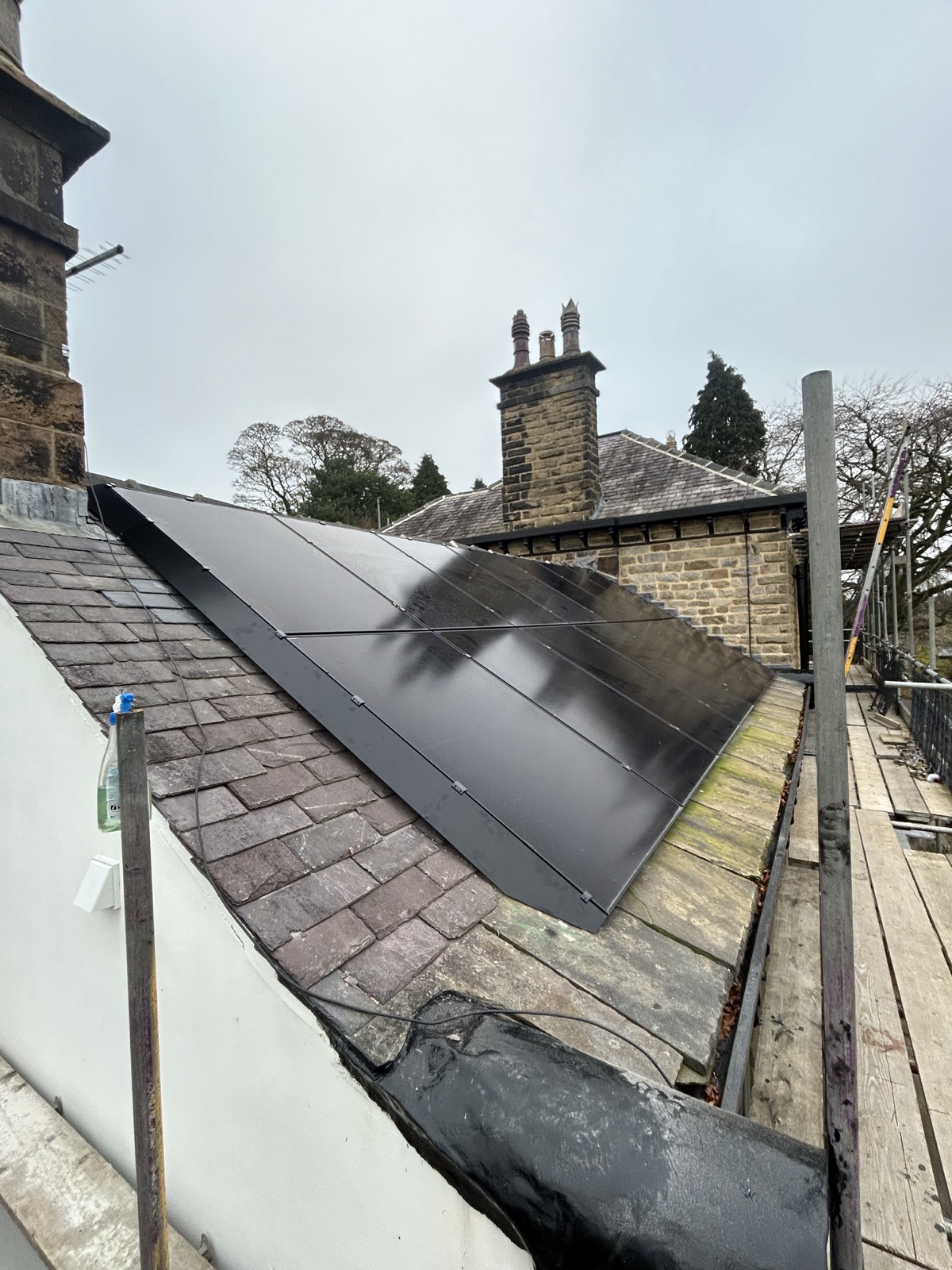 All-black LONGi solar panel array installed on a lower roof elevation