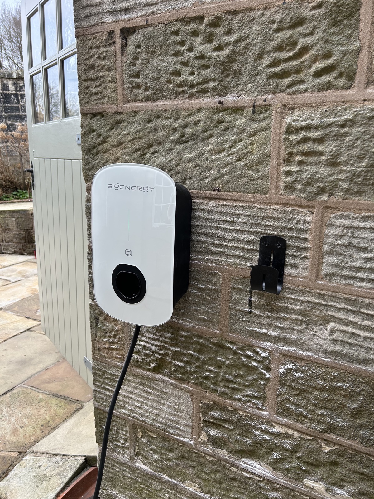Sigenergy 7 kW electric vehicle charger installed on the stone property