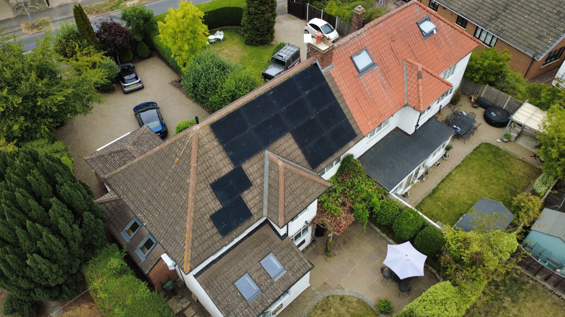 Aerial view of 14 all-black AIKO solar panels installed on a home in Yarm